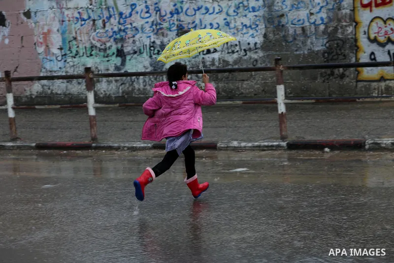 A Palestinian girl walks with her umbrella under the rain, during a winter storm in Gaza city, on january 27, 2016. Photo by Mohammed Asad