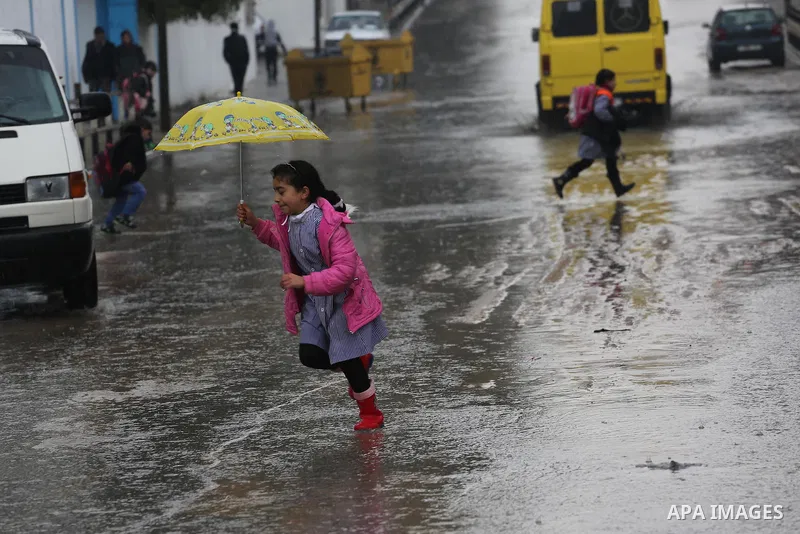 A Palestinian girl walks with her umbrella under the rain, during a winter storm in Gaza city, on january 27, 2016. Photo by Mohammed Asad