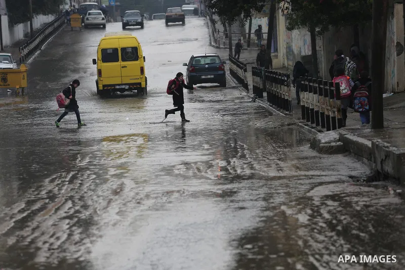Palestinian students walk with their umbrella under the rain, during a winter storm in Gaza city, on january 27, 2016. Photo by Mohammed Asad
