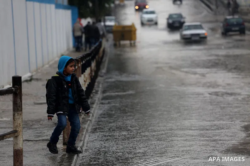 Palestinian students walk with their umbrella under the rain, during a winter storm in Gaza city, on january 27, 2016. Photo by Mohammed Asad