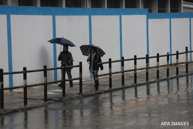 Palestinian students walk with their umbrella under the rain, during a winter storm in Gaza city, on january 27, 2016. Photo by Mohammed Asad