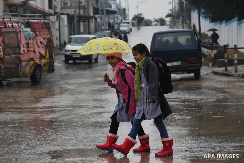 Palestinian students walk with their umbrella under the rain, during a winter storm in Gaza city, on january 27, 2016. Photo by Mohammed Asad
