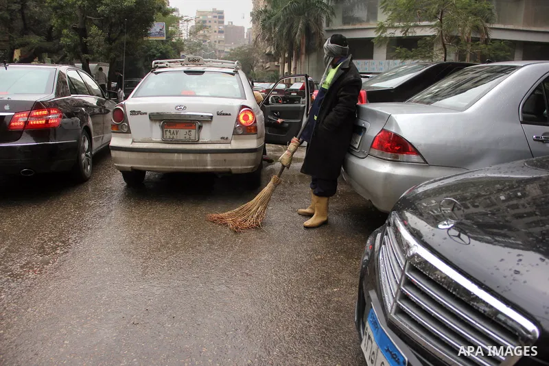 Egyptians walk in a street flooded by rain water, during a winter storm in Cairo, Egypt, on January 27, 2016. Photo by Amr Sayed