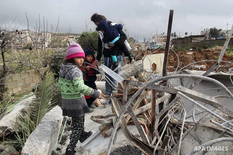Palestinians look at the rubble of their house that was demolished by Israeli bulldozerst, in the Arab east Jerusalem neighbourhood of Shuafat on January 27, 2016. Palestinian homes built without an Israeli construction...