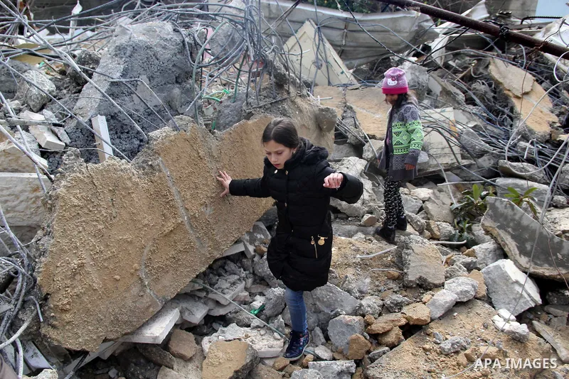 Palestinians look at the rubble of their house that was demolished by Israeli bulldozerst, in the Arab east Jerusalem neighbourhood of Shuafat on January 27, 2016. Palestinian homes built without an Israeli construction...