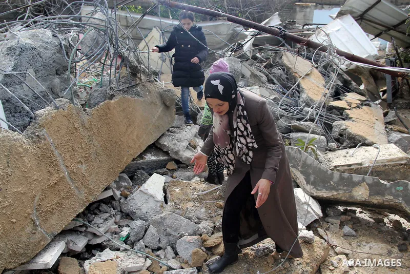Palestinians look at the rubble of their house that was demolished by Israeli bulldozerst, in the Arab east Jerusalem neighbourhood of Shuafat on January 27, 2016. Palestinian homes built without an Israeli construction...