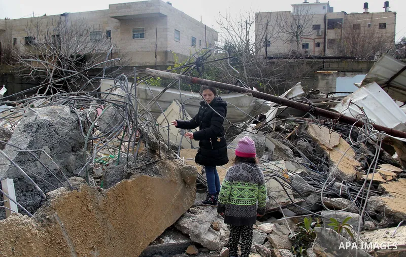 Palestinians look at the rubble of their house that was demolished by Israeli bulldozerst, in the Arab east Jerusalem neighbourhood of Shuafat on January 27, 2016. Palestinian homes built without an Israeli construction...