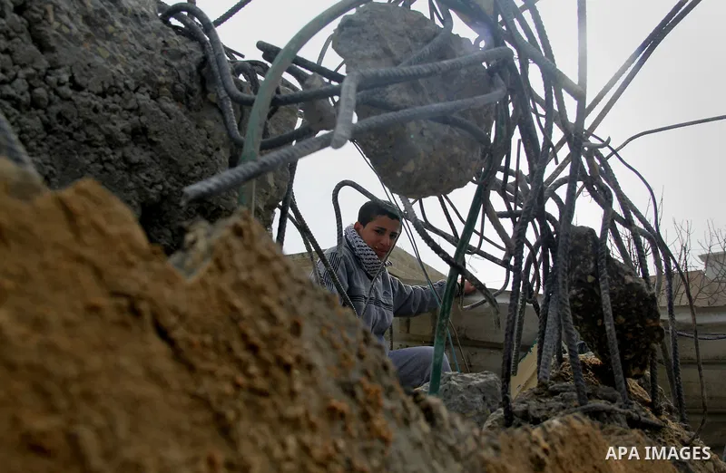 Palestinians look at the rubble of their house that was demolished by Israeli bulldozerst, in the Arab east Jerusalem neighbourhood of Shuafat on January 27, 2016. Palestinian homes built without an Israeli construction...