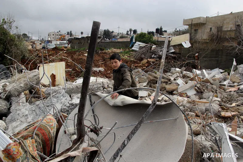 Palestinians look at the rubble of their house that was demolished by Israeli bulldozerst, in the Arab east Jerusalem neighbourhood of Shuafat on January 27, 2016. Palestinian homes built without an Israeli construction...