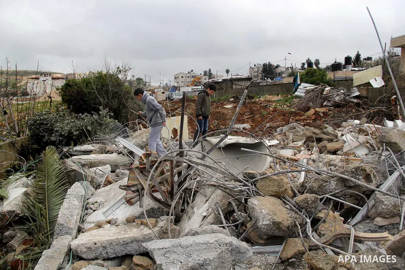 Palestinians look at the rubble of their house that was demolished by Israeli bulldozerst, in the Arab east Jerusalem neighbourhood of Shuafat on January 27, 2016. Palestinian homes built without an Israeli construction...