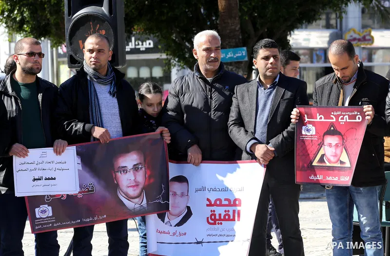Palestinian Journalists hold pictures of journalist Mohammed al-Qeq, who has been on a hunger strike in an Israeli jail for 65 days, during a protest to show solidarity with him, in Gaza city January 28, 2016. Qeq went o...