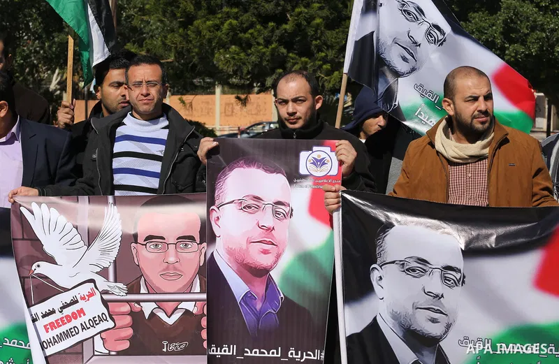 Palestinian Journalists hold pictures of journalist Mohammed al-Qeq, who has been on a hunger strike in an Israeli jail for 65 days, during a protest to show solidarity with him, in Gaza city January 28, 2016. Qeq went o...
