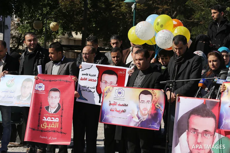 Palestinian Journalists hold pictures of journalist Mohammed al-Qeq, who has been on a hunger strike in an Israeli jail for 65 days, during a protest to show solidarity with him, in Gaza city January 28, 2016. Qeq went o...