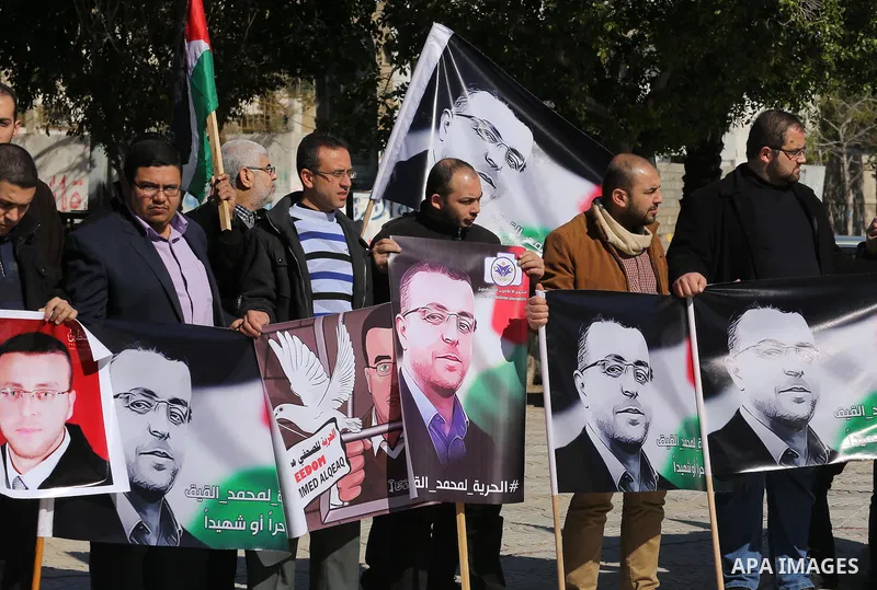 Palestinian Journalists hold pictures of journalist Mohammed al-Qeq, who has been on a hunger strike in an Israeli jail for 65 days, during a protest to show solidarity with him, in Gaza city January 28, 2016. Qeq went o...