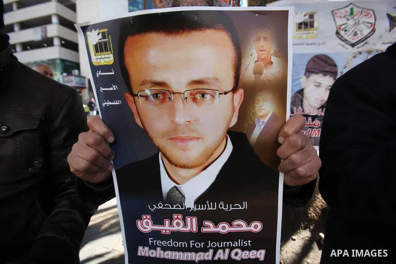 Palestinians hold pictures of journalist Mohammed al-Qeq, who has been on a hunger strike in an Israeli jail for 65 days, during a protest to show solidarity with him, in the West bank city of Nablus, on January 28, 2016...