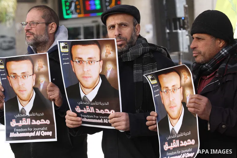 Palestinians hold pictures of journalist Mohammed al-Qeq, who has been on a hunger strike in an Israeli jail for 65 days, during a protest to show solidarity with him, in the West bank city of Nablus, on January 28, 2016...