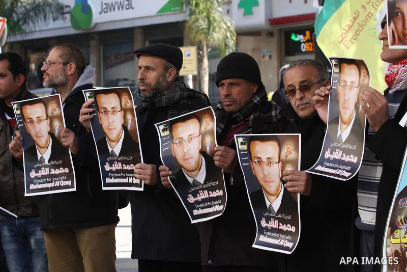 Palestinians hold pictures of journalist Mohammed al-Qeq, who has been on a hunger strike in an Israeli jail for 65 days, during a protest to show solidarity with him, in the West bank city of Nablus, on January 28, 2016...