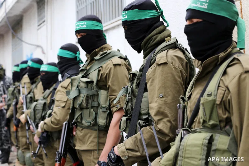 Palestinian members of Ezzedeen al-Qassam, the armed wing of Hamas movement, take part during the funeral of Palestinian Hamas militants whom killed after a tunnel, built for fighting Israel, collapsed in the Gaza Strip,...