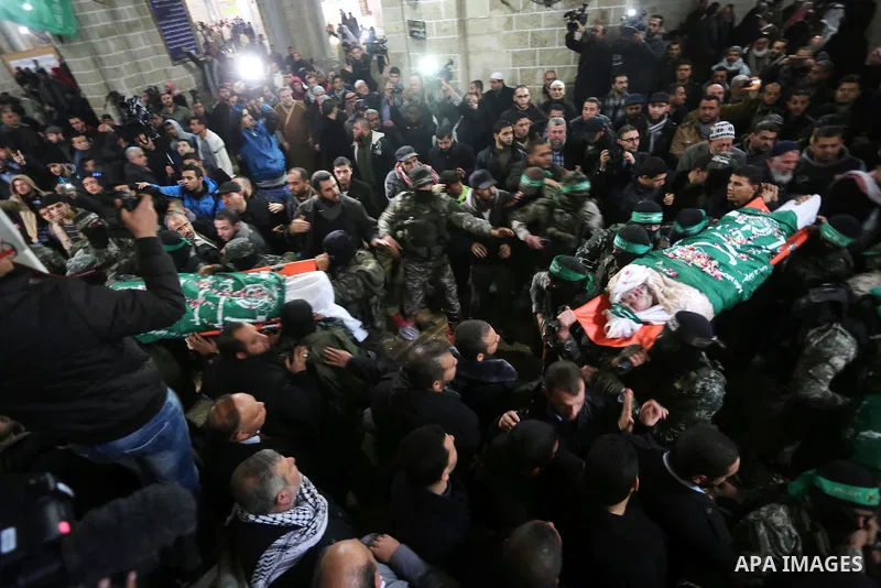 Palestinian members of Ezzedeen al-Qassam, the armed wing of Hamas movement, carry the bodies of the seven Palestinian Hamas militants whom killed after a tunnel, built for fighting Israel, collapsed in the Gaza Strip, d...