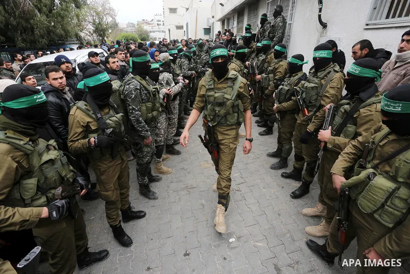 Palestinian members of Ezzedeen al-Qassam, the armed wing of Hamas movement, take part during the funeral of Palestinian Hamas militants whom killed after a tunnel, built for fighting Israel, collapsed in the Gaza Strip,...