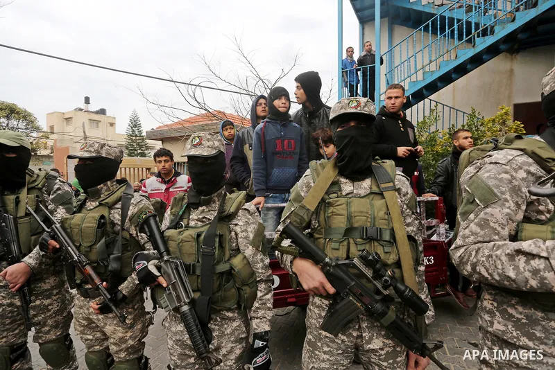 Palestinian members of Ezzedeen al-Qassam, the armed wing of Hamas movement, take part during the funeral of Palestinian Hamas militants whom killed after a tunnel, built for fighting Israel, collapsed in the Gaza Strip,...