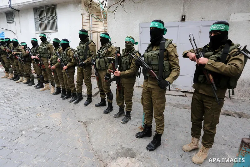 Palestinian members of Ezzedeen al-Qassam, the armed wing of Hamas movement, take part during the funeral of Palestinian Hamas militants whom killed after a tunnel, built for fighting Israel, collapsed in the Gaza Strip,...