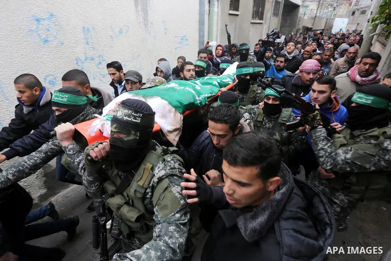 Palestinian members of Ezzedeen al-Qassam, the armed wing of Hamas movement, carry the body of one of the seven Palestinian Hamas militants whom killed after a tunnel, built for fighting Israel, collapsed in the Gaza Str...