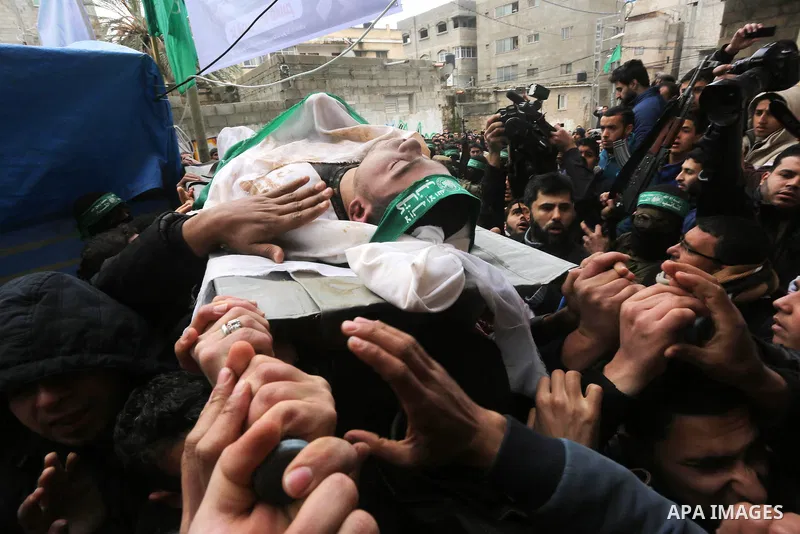 Palestinians carry the body of one of the seven Palestinian Hamas militants whom killed after a tunnel, built for fighting Israel, collapsed in the Gaza Strip, during their funeral in Gaza City on January 29, 2016. Seven...