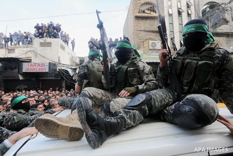 Palestinian members of Ezzedeen al-Qassam, the armed wing of Hamas movement, take part during the funeral of Palestinian Hamas militants whom killed after a tunnel, built for fighting Israel, collapsed in the Gaza Strip,...