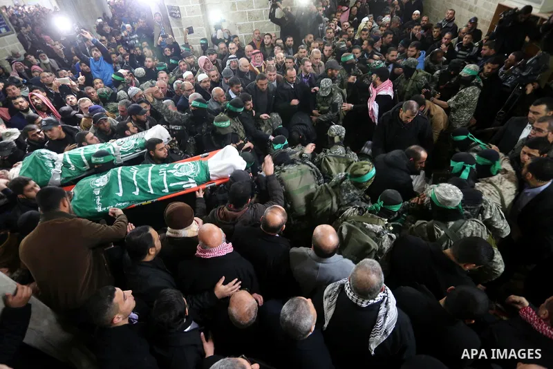 Palestinian members of Ezzedeen al-Qassam, the armed wing of Hamas movement, carry the bodies of the seven Palestinian Hamas militants whom killed after a tunnel, built for fighting Israel, collapsed in the Gaza Strip, d...