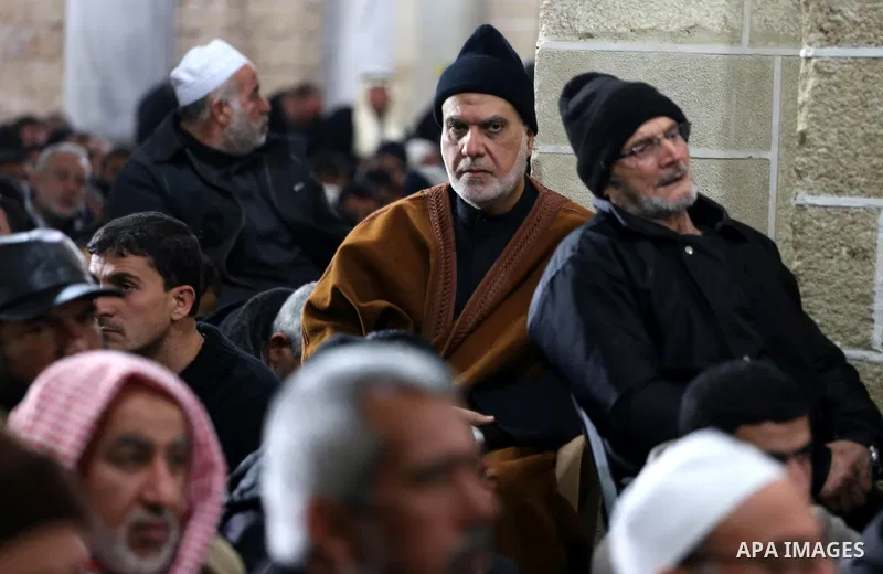 Palestinians pray at a mosque near the bodies of the seven Palestinian Hamas militants whom killed after a tunnel, built for fighting Israel, collapsed in the Gaza Strip, during their funeral in Gaza City on January 29,...