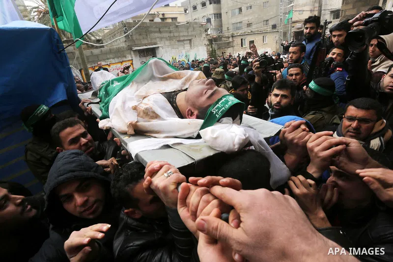 Palestinians carry the body of one of the seven Palestinian Hamas militants whom killed after a tunnel, built for fighting Israel, collapsed in the Gaza Strip, during their funeral in Gaza City on January 29, 2016. Seven...