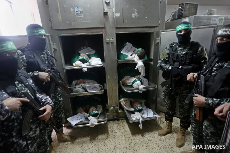 Palestinian Hamas militants look at the bodies of Hamas militants killed after a tunnel, built for fighting Israel, collapsed in the Gaza Strip, at the morgue in the al-Shifa hospital in Gaza City on January 29, 2016. Se...