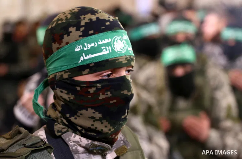 Palestinian members of Ezzedeen al-Qassam, the armed wing of Hamas movement, take part during the funeral of Palestinian Hamas militants whom killed after a tunnel, built for fighting Israel, collapsed in the Gaza Strip,...