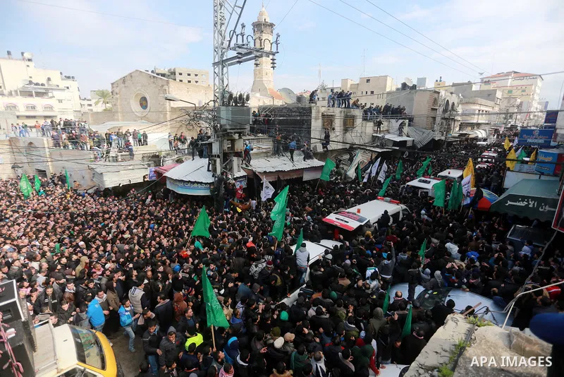 Mourners gather around ambulances carrying the bodies of seven Hamas militants who were killed after a tunnel built for fighting Israel collapsed in the Gaza Strip, during their funeral in Gaza City on January 29, 2016....