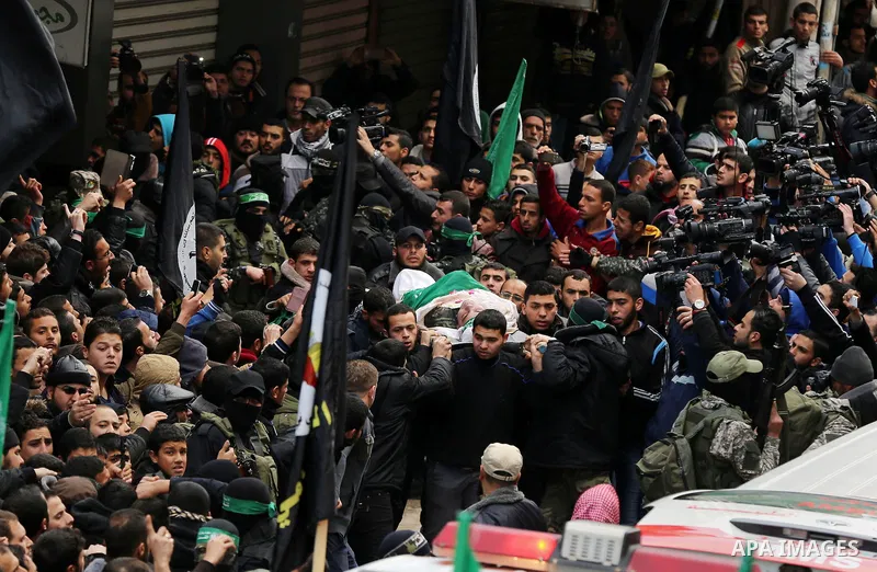 Mourners gather around ambulances carrying the bodies of seven Hamas militants who were killed after a tunnel built for fighting Israel collapsed in the Gaza Strip, during their funeral in Gaza City on January 29, 2016....