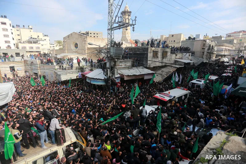 Mourners gather around ambulances carrying the bodies of seven Hamas militants who were killed after a tunnel built for fighting Israel collapsed in the Gaza Strip, during their funeral in Gaza City on January 29, 2016....