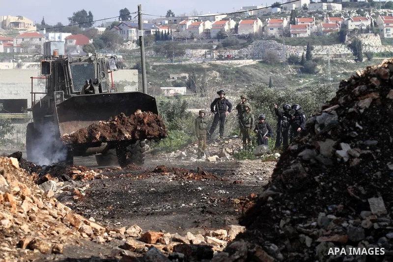 Israeli secrity forces take position during clashes with Palestinian protesters following a protest against the expropriation of Palestinian land by Israel in the West Bank village of Kafr Qaddum, near the northern city...