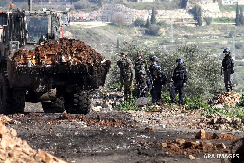 Israeli secrity forces take position during clashes with Palestinian protesters following a protest against the expropriation of Palestinian land by Israel in the West Bank village of Kafr Qaddum, near the northern city...
