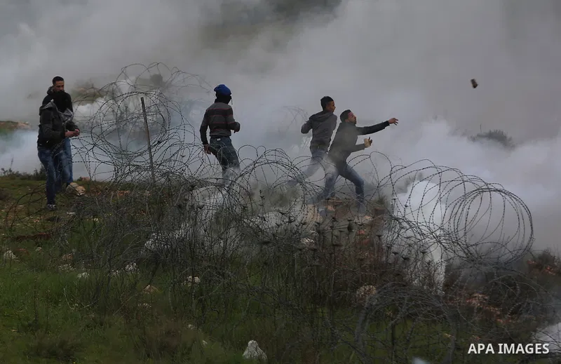 Palestinian protesters clash with Israeli security forces following a demonstration in solidarity with Palestinian prisoners in Israeli jails, outside the compound of the Israeli Ofer Military Prison, near the West Bank...