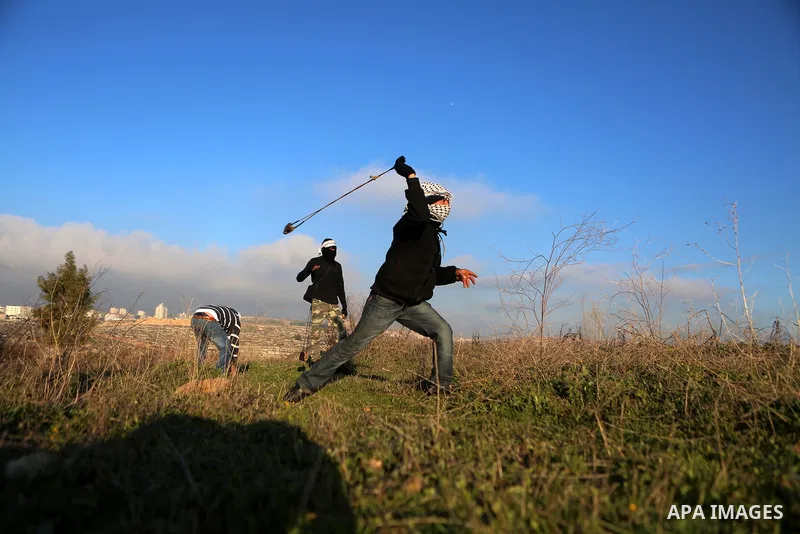 Palestinian protesters clash with Israeli security forces following a demonstration in solidarity with Palestinian prisoners in Israeli jails, outside the compound of the Israeli Ofer Military Prison, near the West Bank...