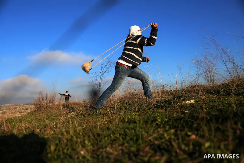 Palestinian protesters clash with Israeli security forces following a demonstration in solidarity with Palestinian prisoners in Israeli jails, outside the compound of the Israeli Ofer Military Prison, near the West Bank...