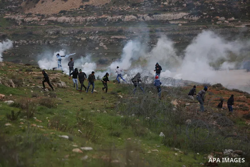 Palestinian protesters clash with Israeli security forces following a demonstration in solidarity with Palestinian prisoners in Israeli jails, outside the compound of the Israeli Ofer Military Prison, near the West Bank...