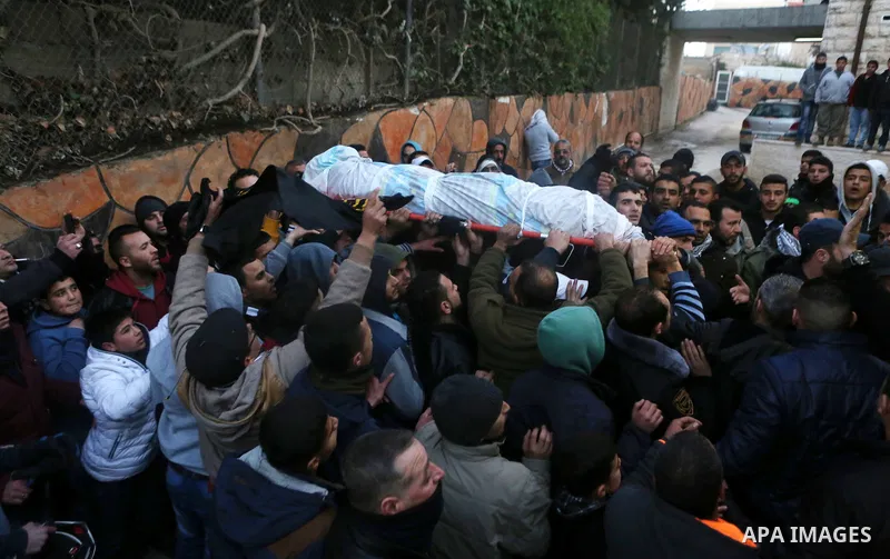 Palestinian men carry a body of a Palestinian alleged attacker Hussein Abu Ghush, 17, upon its release by the Israeli security forces in the West Bank city of Ramallah, on Jan 29, 2016. Israeli authorities announced on T...