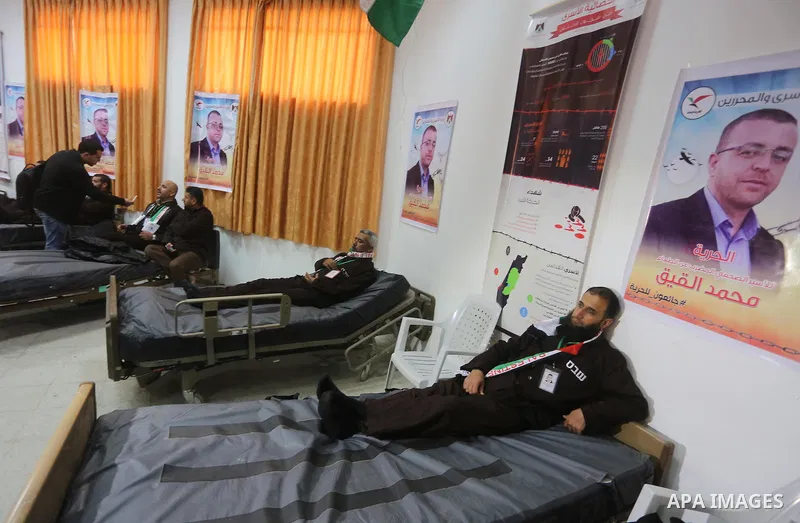 Palestinians on a hunger strike in solidarity with journalist Mohammed al-Qiq who is imprisoned in an Israeli jail at the Ministry of Prisoners, in Gaza City, on January 30, 2016. Qiq is being held under Israel's controv...