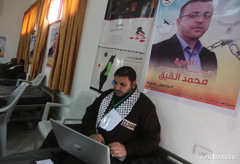 Palestinians on a hunger strike in solidarity with journalist Mohammed al-Qiq who is imprisoned in an Israeli jail at the Ministry of Prisoners, in Gaza City, on January 30, 2016. Qiq is being held under Israel's controv...