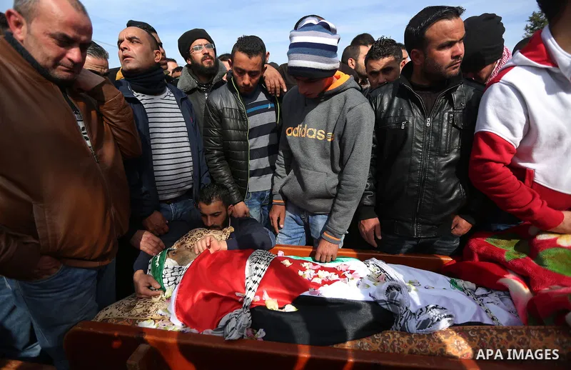 Relatives mourn over the body of a Palestinian Ibrahim Allan, 22, upon its release by the Israeli security forces, during his funeral, in the West Bank city of Ramallah, on Jan 30, 2016. Israeli authorities announced on...