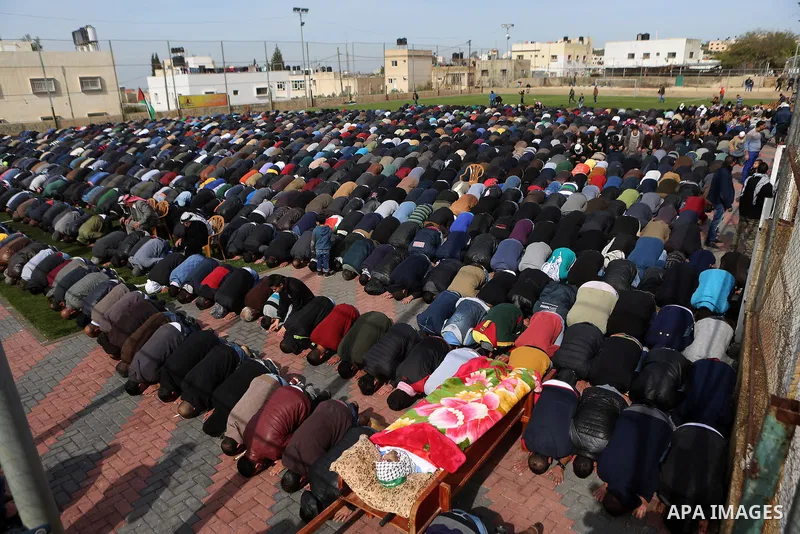 Relatives pray the body of a Palestinian Ibrahim Allan, 22, upon its release by the Israeli security forces, during his funeral, in the West Bank city of Ramallah, on Jan 30, 2016. Israeli authorities announced on Thursd...