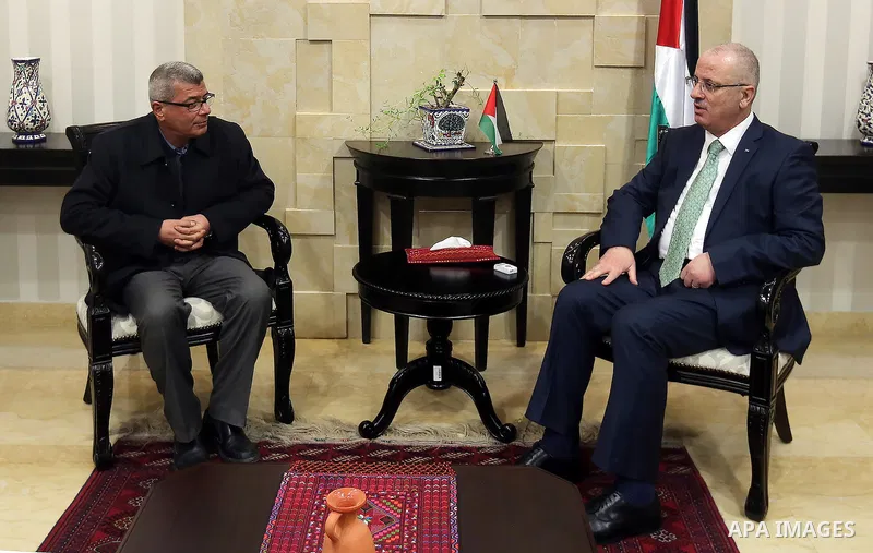 Palestinian Prime Minister Rami Hamdallah meets with the family of Palestinian journalist Mohammed al-Qiq who is on hunger strike in an Israeli jail for 68 days in the West Bank city of Ramallah on Jan. 31, 2016. Photo b...