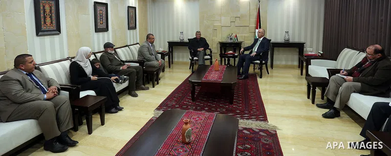 Palestinian Prime Minister Rami Hamdallah meets with the family of Palestinian journalist Mohammed al-Qiq who is on hunger strike in an Israeli jail for 68 days in the West Bank city of Ramallah on Jan. 31, 2016. Photo b...